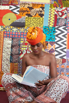 Woman wearing a headscarf reading