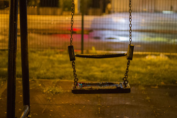 An empty swing in the park in the rainy night - 272032771