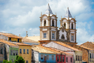 Fototapeta na wymiar Colorful historic district of Pelourinho with cathedral on the background. The historic center of Salvador, Bahia, Brazil. Historic neighborhood famous attraction for tourist sightseeing. 