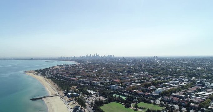 Melbourn coastline featuring the distant skyline and clear Australian ocean 24
