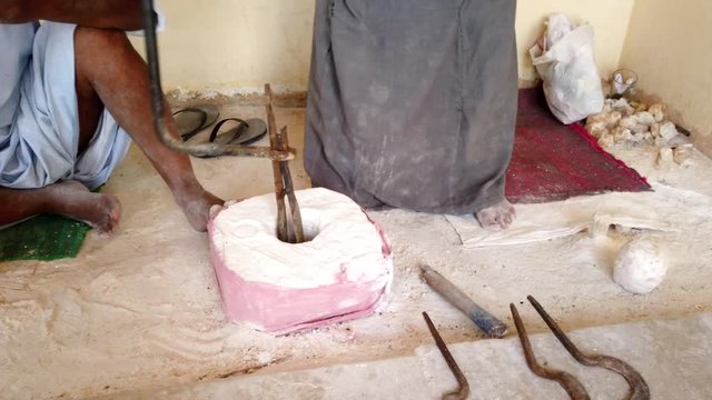 Man Uses Ancient Tool To Carve Out Center of What Will Become a Stone Vase.