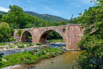 Fototapeta na wymiar Old medieval bridge over the river Aude, in the center of Alet les Bains, France