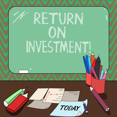 Conceptual hand writing showing Return On Investment. Business photo showcasing measures the gain or loss generated on an investment Mounted Blackboard with Chalk Writing Tools Sheets on Desk