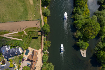 Naklejka premium Overhead view of two boats and houses on the river Thames in Marlow, Buckinghamshire, UK