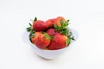 white bowl with fresh big strawberry on white background