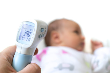 Measure baby's fever with digital fever meter. sick baby with high fever