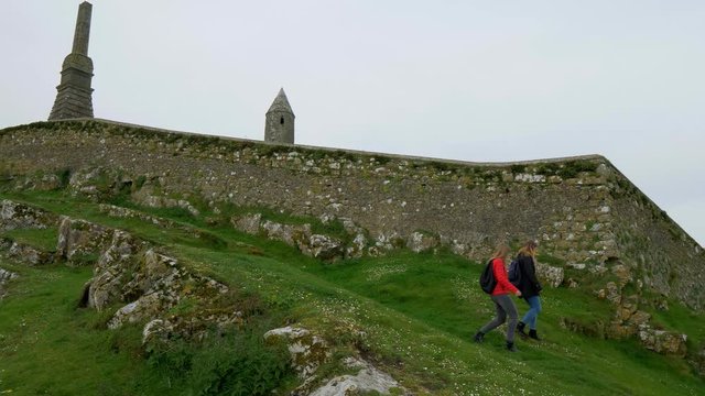 Two young woman on a sightseeing trip to the Rock of Cashel in Ireland - travel photography