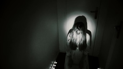 Creepy POV nightmare. A man enters dark hallway and encounters a monster with candles. Exorcism, ghost or evil apparition.