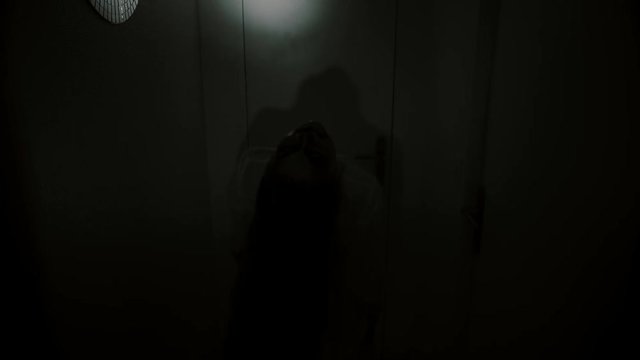 Creepy POV nightmare. A man enters dark hallway and encounters a monster with candles. Exorcism, ghost or evil apparition.