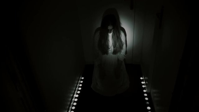 Creepy POV nightmare. A man enters dark hallway and encounters a monster with candles. Exorcism, ghost or evil apparition.