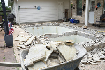Empty swimming pool after demolishing old tile and coping for remodel