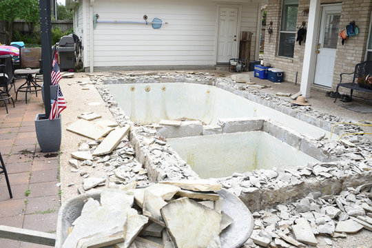 Empty swimming pool after demolishing old tile and coping for remodel