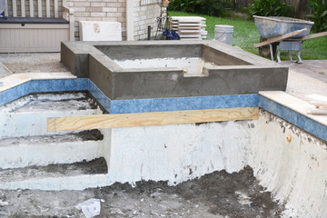 Empty swimming pool hot tub with new concrete after remodel