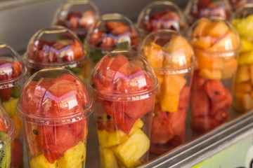 Assorted fresh fruit salad in plastic cups