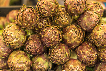 Fototapeta premium Close up of several fresh italian artichokes at fair