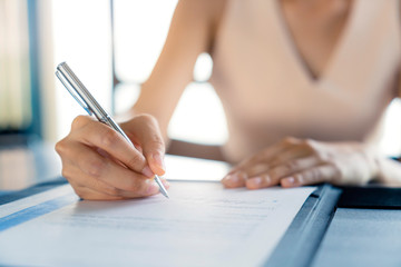 business investor woman success deal contract with paper sign close up hand hold pen sign contract