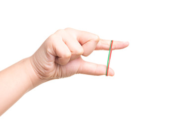 Child hand playing with elastic rubber band isolated on white