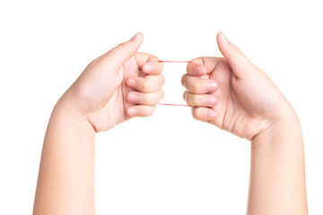 Child hand playing with elastic rubber band isolated on white