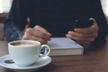 Man using smartphone in coffee shop