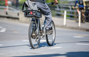 Fototapeta na wymiar Cyclists active lifestyle lovers ride bikes along city street alongside other traffic