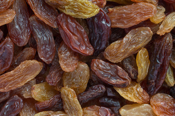 close up of dark brown and golden raisins background