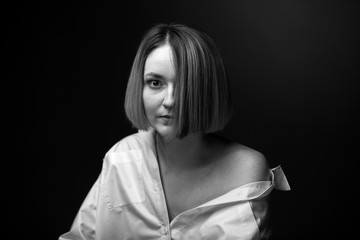 Dramatic black and white portrait of a beautiful woman on a dark background