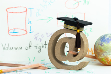Email address symbol and Graduation cap on formula arithmetic equation background near globe pencils, Concept of success in online / e-learning mathematics study abroad education world knowledge