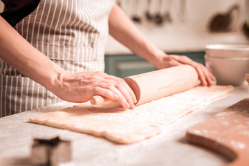 Close up of female hands that using rolling pin