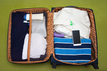 Open suitcase with things. Things collected for the trip.