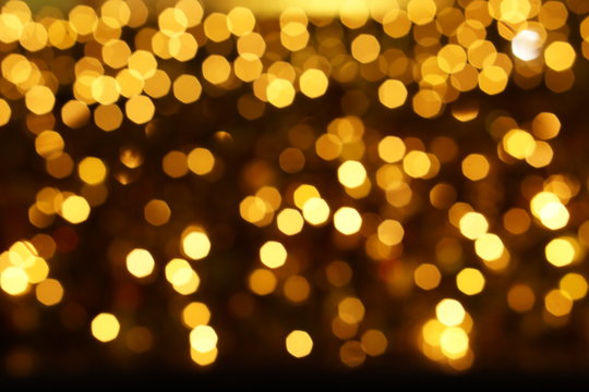 Abstract blurred and bokeh of party yellow LED reflection lighting on night time background.