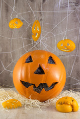 Jack lantern for Halloween of a basketball on a wooden background with spider webs.