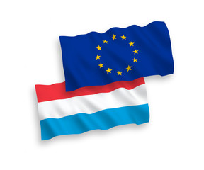 National vector fabric wave flags of European Union and Luxembourg isolated on white background. 1 to 2 proportion.