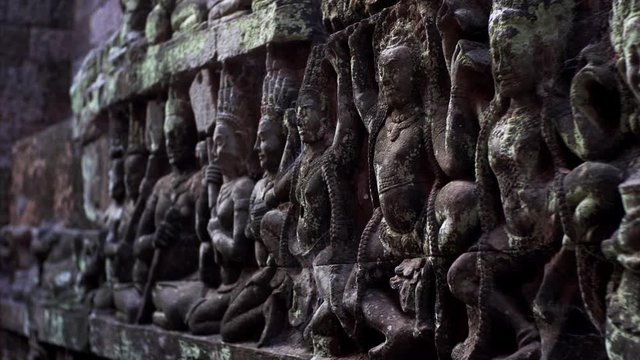 Close view of detailed bas-reliefs of the Leper King terrace located in the northwest corner of the Royal Square of Angkor Thom, Cambodia.