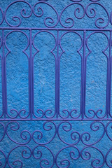 Textured blue wall with ironwork design