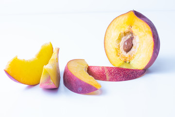 Close up of beautiful elegant composition from ripe juicy red nectarines on white background