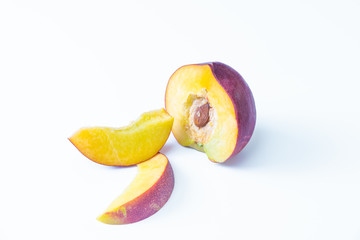 Isolated nectarines. A half nectarine peaches and two small slices isolated on white background