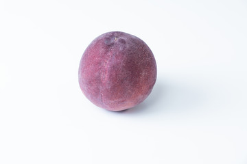 Top view of a purple nectarine on white background. Isolated isolated nectarine