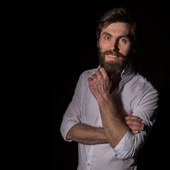 Portrait handsome bearded man, sexy guy on a dark background