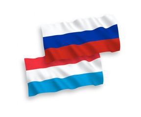 National vector fabric wave flags of Luxembourg and Russia isolated on white background. 1 to 2 proportion.