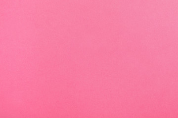 Pink paper sheet as color background, top view