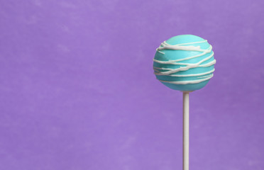 Bright delicious cake pop on color background. Space for text