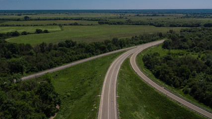 Fototapeta na wymiar Aerial view of 3 highway road connected in 1 interchange seen from above.