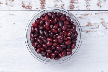 A bowl with red dry uncooked beans	