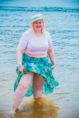 Nice plus size american xxl woman with plump figure, natural woman’s big beauty on a beach