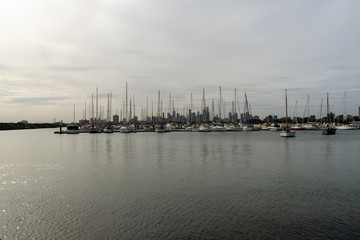 sunset on the pier of st. Kilda with boat at the harbor and Melbourne in the background