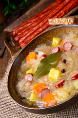 rustic sauerkraut soup with bacon and sausage