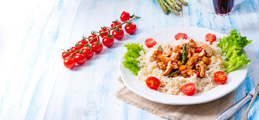 Turkey fricassee on rice with asparagus and paprika