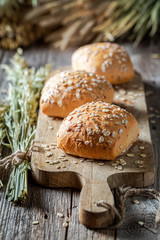 Healthy and fresh rolls with oat flakes on wooden table