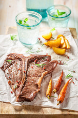 Tbone steak with chips served with water
