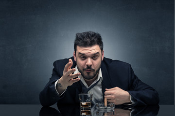 Young drunk man at his office with free dark copyspace